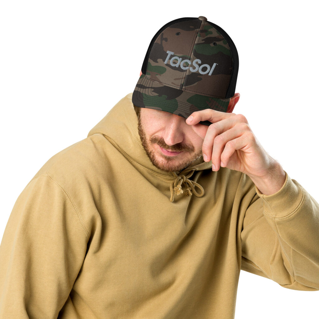 A guy wearing a camo hat with the silver TacSol text logo