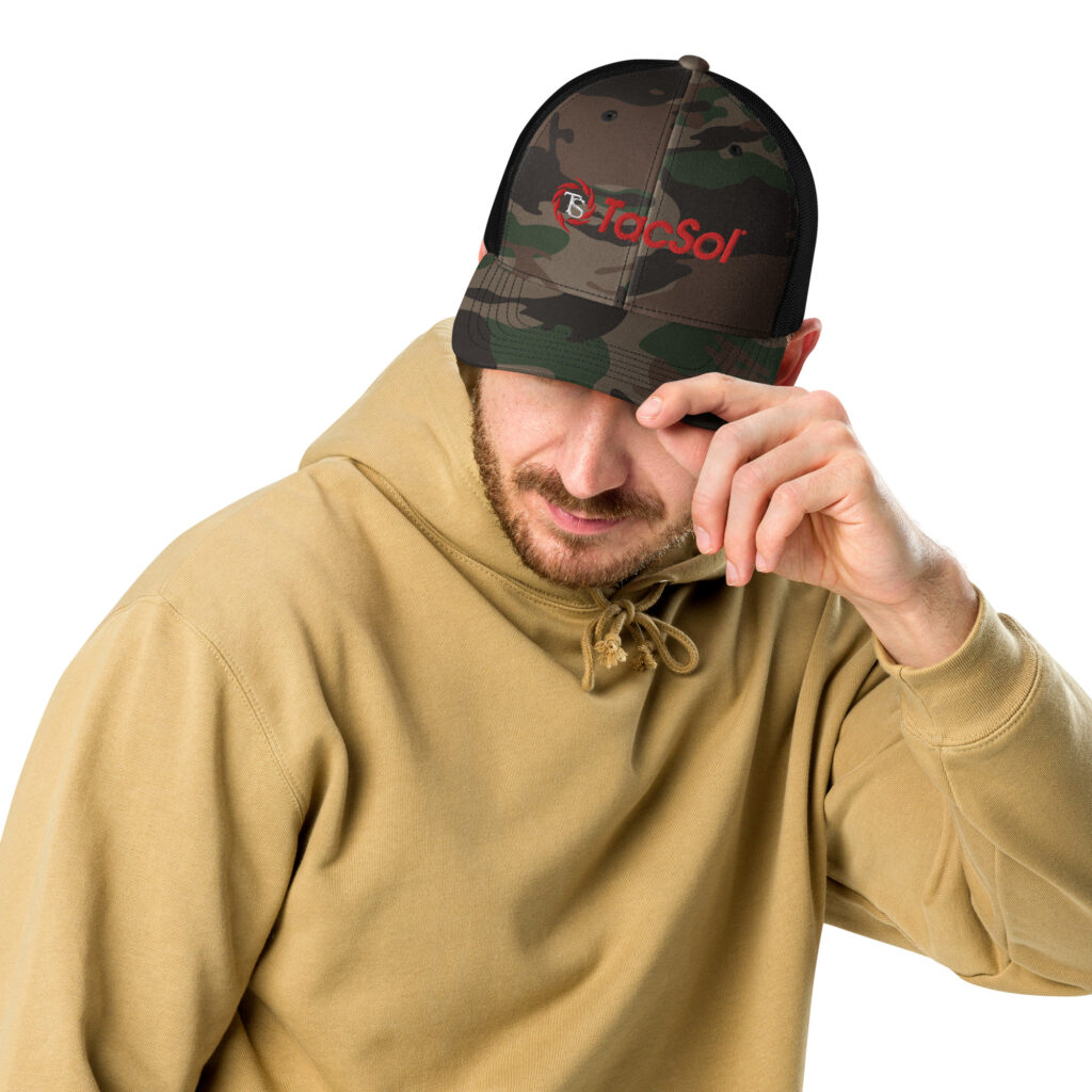 A guy wearing a camo hat with the full read TacSol logo