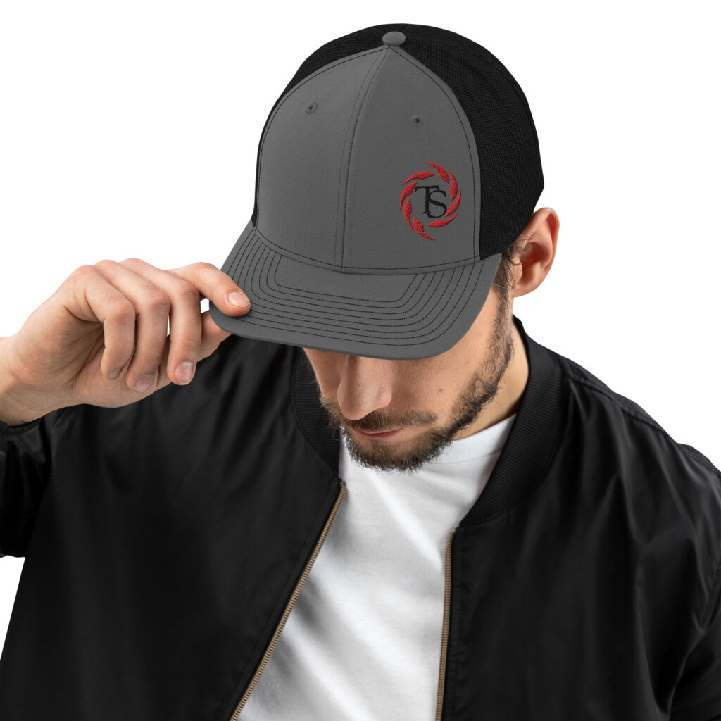 Guy wearing a grey trucker cap with the red TacSol swirl logo