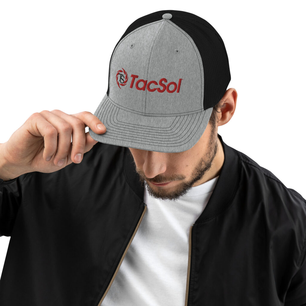 Guy wearing a grey trucker hat the the full red TacSol logo