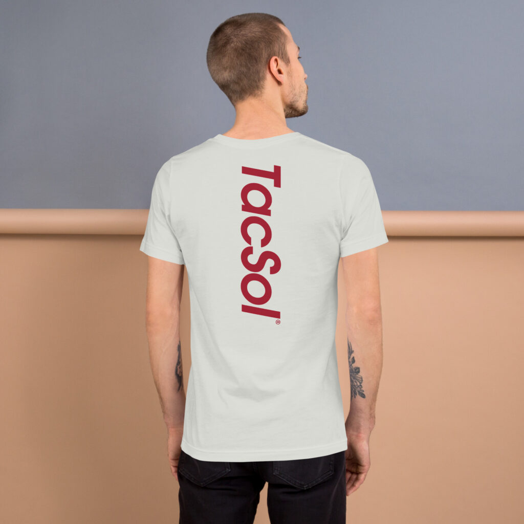Back view of a man wearing a white shirt with the TacSol logo across the back of his shirt