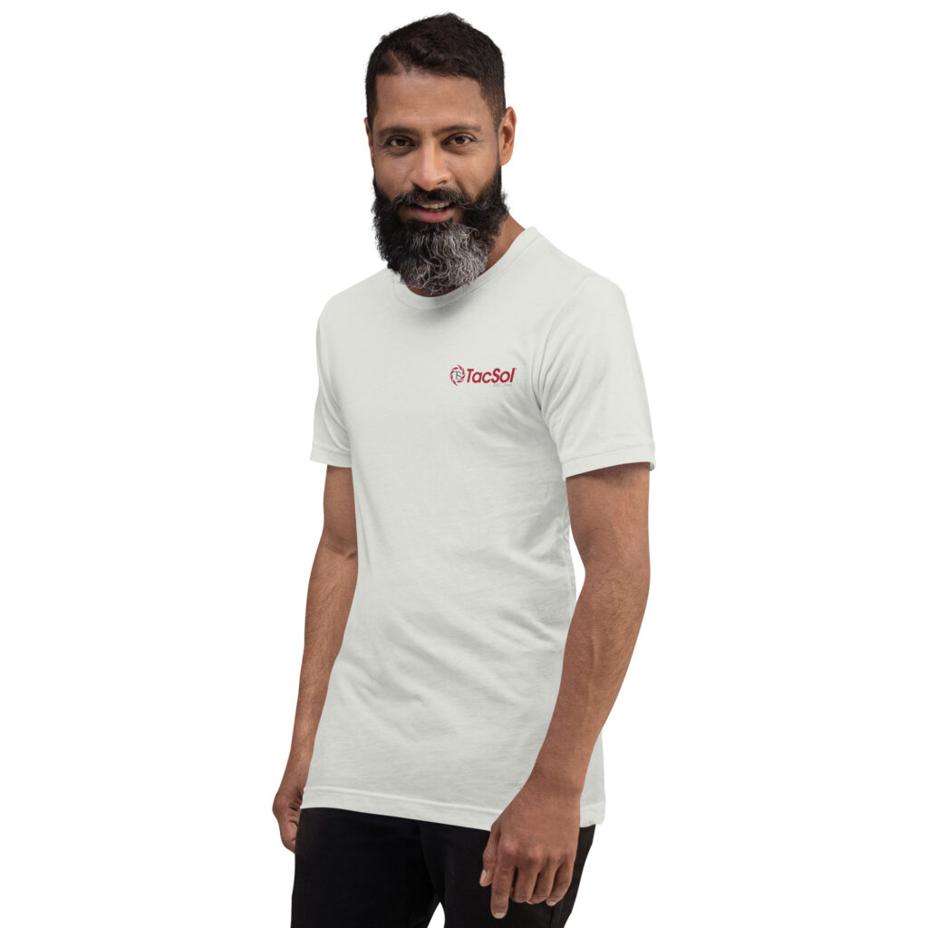 A man wearing a white t shirt with the full TacSol logo