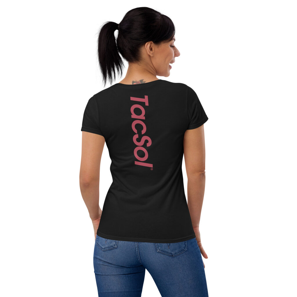 Back view of a woman wearing a black t shirt with the red TacSol text logo printed vertically