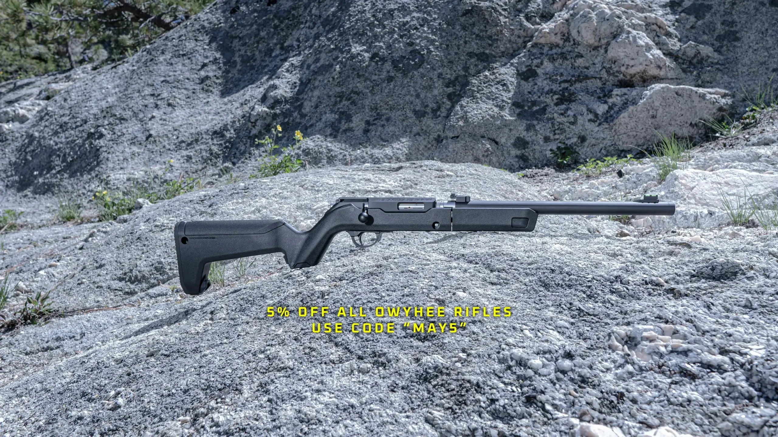 Cinematic image of an owyhee rifle against rock. Text on the image saying "5% off all owyhee rifles use code "MAY5".